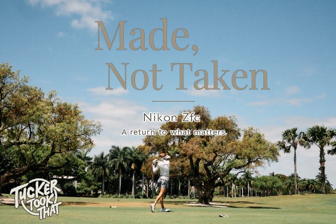 Golfer mid swing on a palm tree lined course photographed with Nikon Zfc.