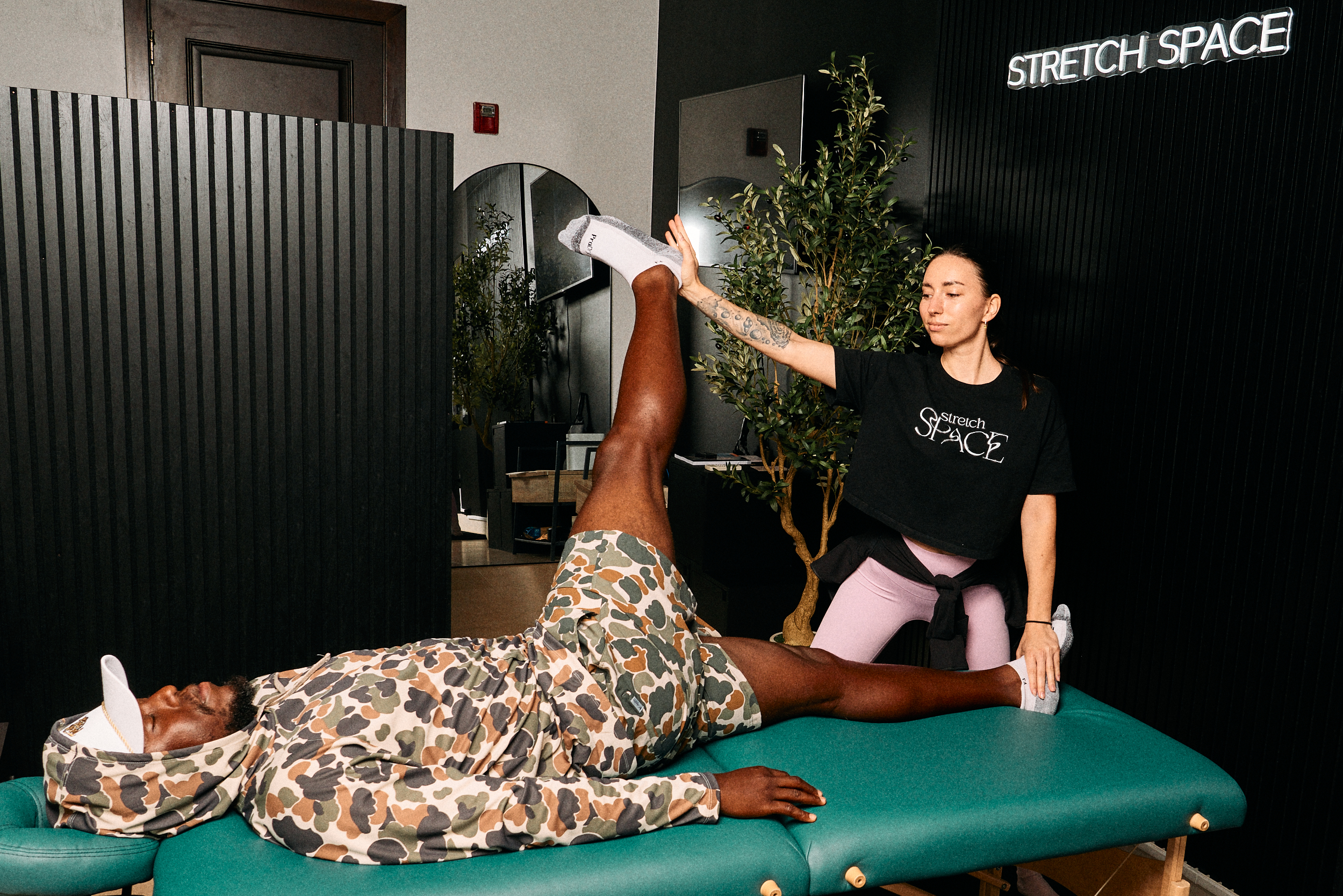 Photographer and golfer Dwayne Tucker during a stretch therapy session at Stretch Space Miami.