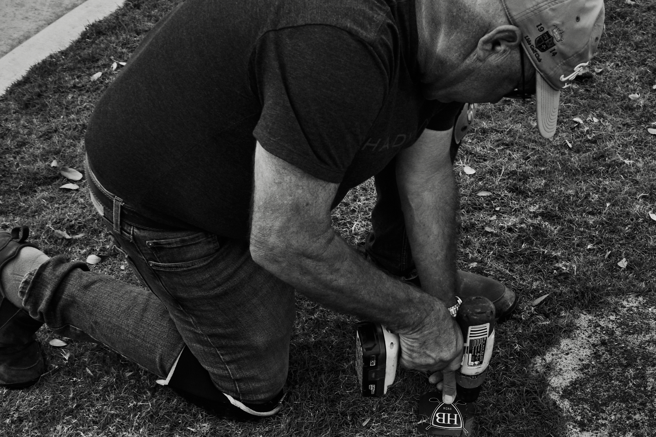 Worker building wooden hole marker signs at Hollywood Beach Golf Club.