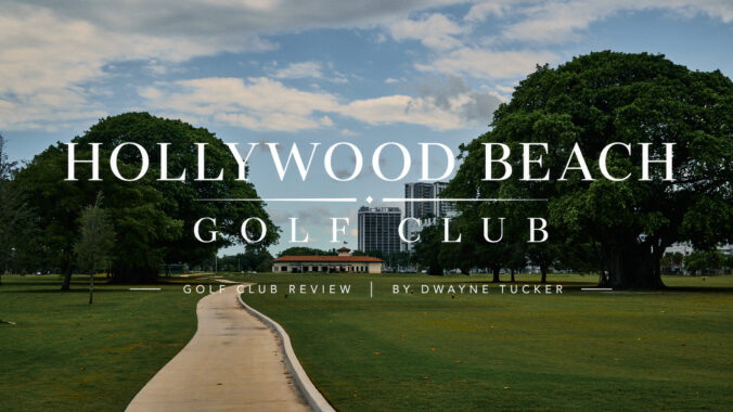 Clubhouse at Hollywood Beach Golf Club viewed from the 18th tee with the American flag flying above the building.